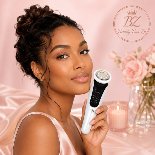 South African woman holding the Beauty Bar Za™ V-Face Lifting & Tightening Device against a blush pink background